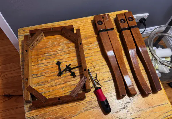 Table legs and structural frame, disassembled and placed on another table