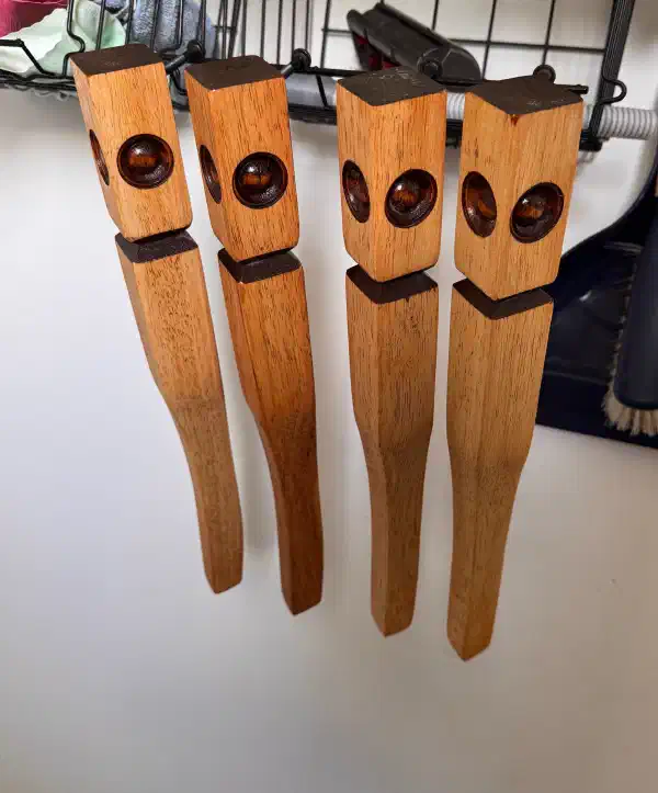 table legs hanging on hooks, slightly darker from multiple coats of tung oil